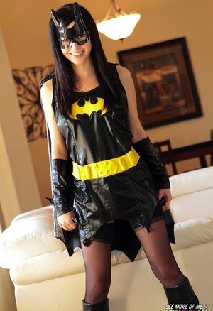 Dark haired chick Catie Minx takes off a Batman suit to model in the nude